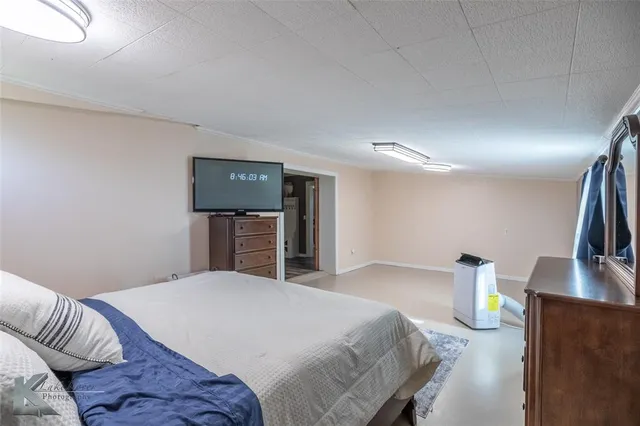 a bedroom with a bed and a television