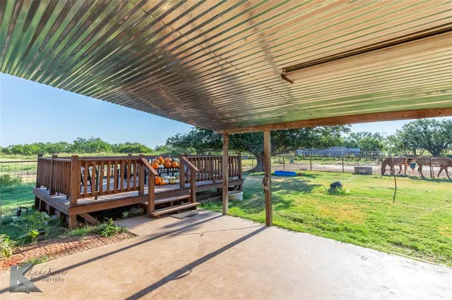 a view of a chair and tables in the backyard