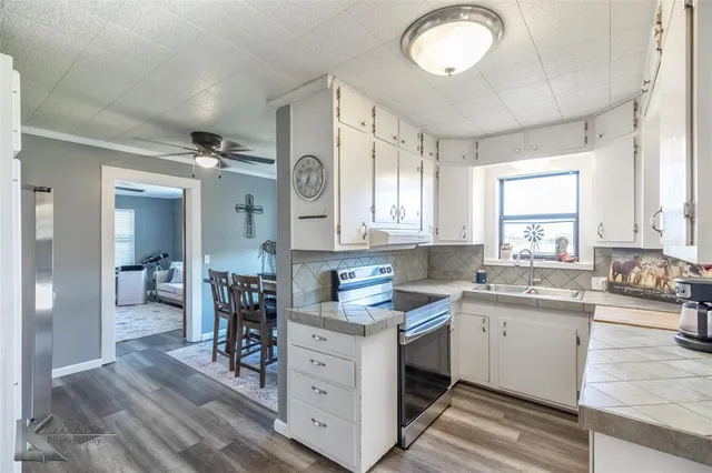 a kitchen with a sink cabinets and window