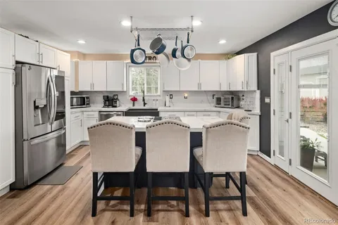a kitchen with a sink a stove and cabinets