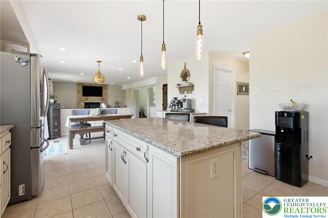 115 West Butternut Road Hellertown, PA 18055 - Photo 19 of 97 A luminous kitchen island with granite counters anchors this inviting, open-concept living space.
