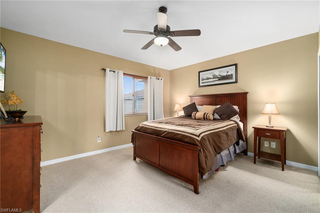 17577 Brickstone Loop Fort Myers, FL 33967 - Photo 12 of 33 a bedroom with a bed and a chandelier