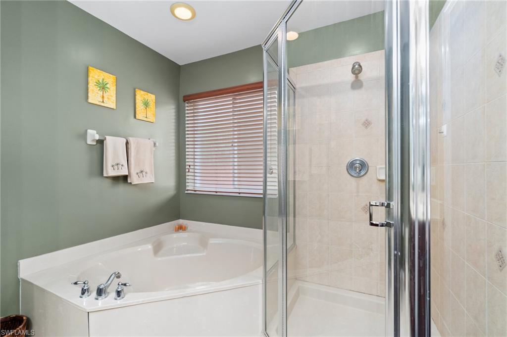 17577 Brickstone Loop Fort Myers, FL 33967 - Photo 16 of 33 a bathroom with a bathtub and a shower