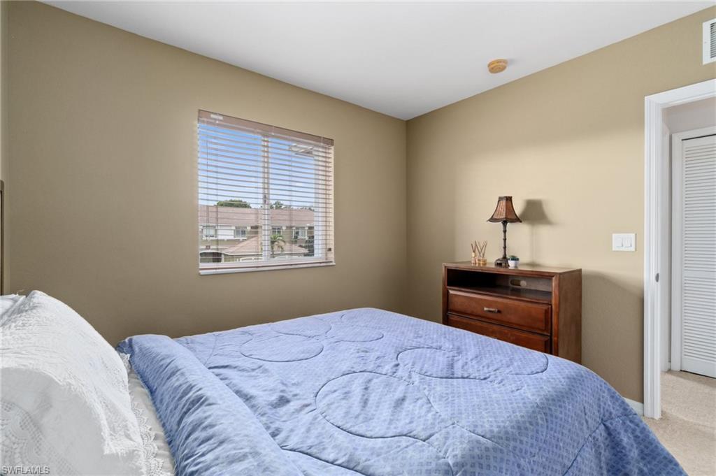 17577 Brickstone Loop Fort Myers, FL 33967 - Photo 22 of 33 a bedroom with a bed and dresser with mirror