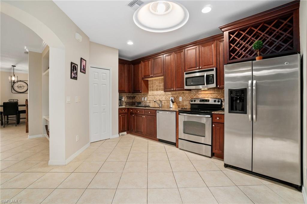 17577 Brickstone Loop Fort Myers, FL 33967 - Photo 10 of 33 a kitchen with stainless steel appliances granite countertop a refrigerator and a stove top oven