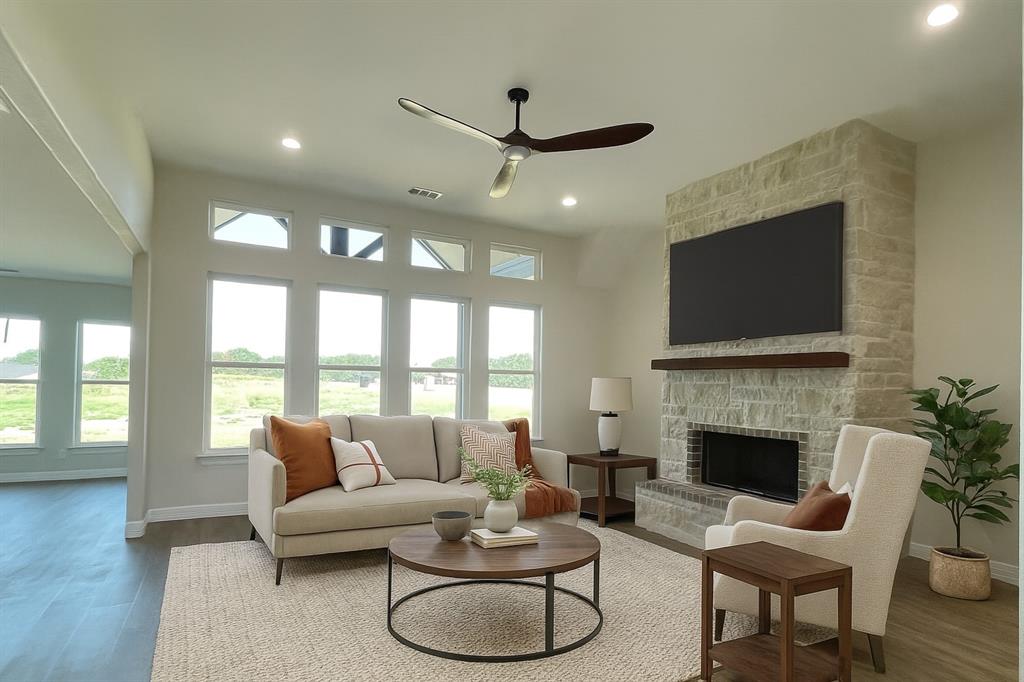 9771 Dripping Spring Road Denison, TX 75021 - Photo 2 of 4 a living room with furniture a fireplace and a flat screen tv
