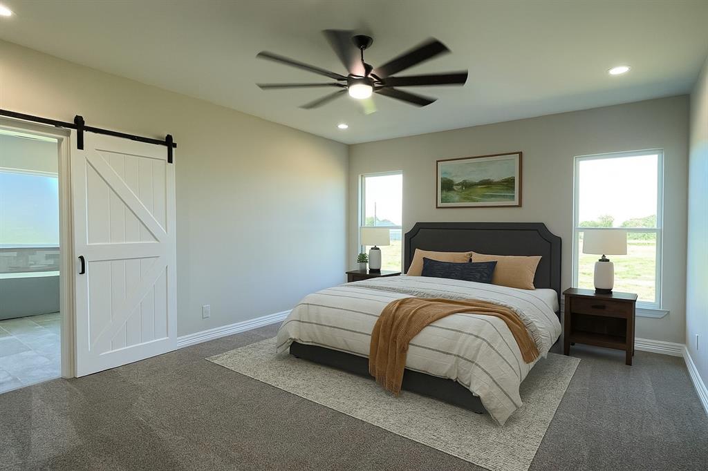 9771 Dripping Spring Road Denison, TX 75021 - Photo 4 of 4 a bedroom with a large bed and a ceiling fan