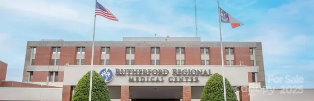a front view of a building with glass door and stairs