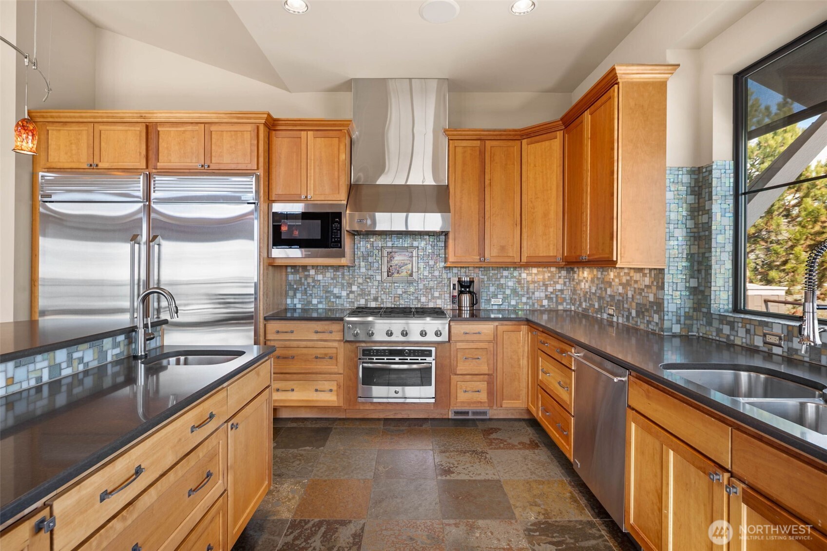232 Crystal Drive Chelan, WA 98816 - Photo 9 of 39 a large kitchen with granite countertop a sink and dishwasher wooden cabinets with a large window