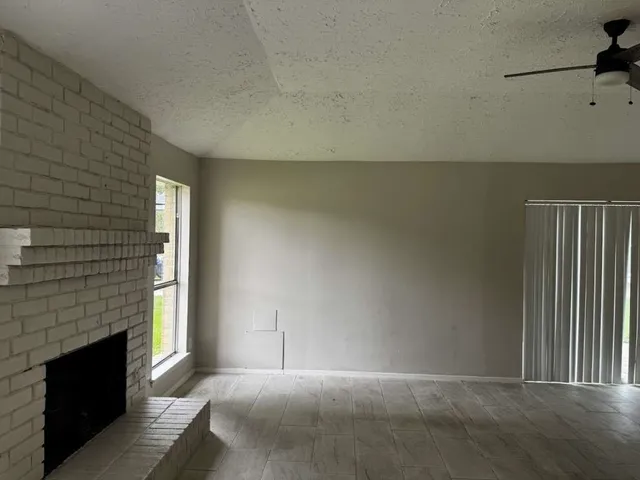 a view of empty room with fireplace