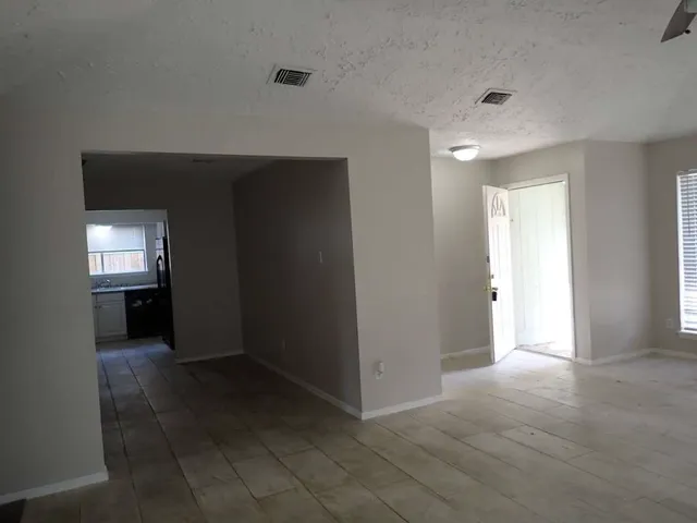 an empty room with closet and a bathroom