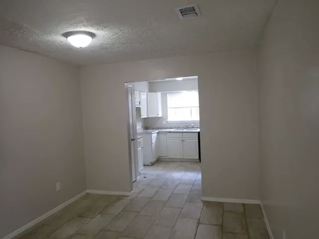 a bathroom with a sink toilet and cabinets