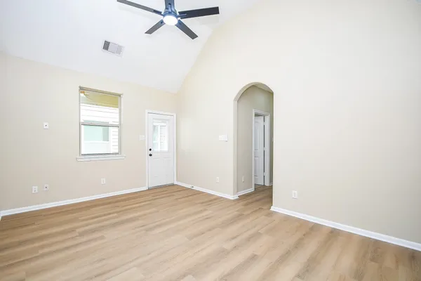 a view of a brick house with wooden floor and floor to ceiling windows