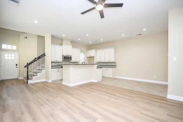 a view of kitchen with sink and refrigerator