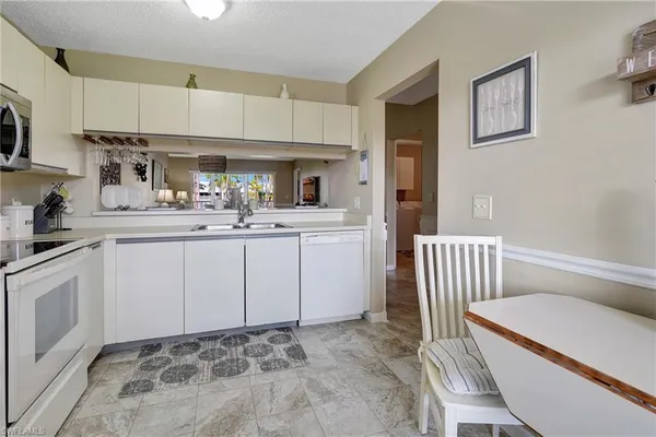 a kitchen with a sink cabinets and window
