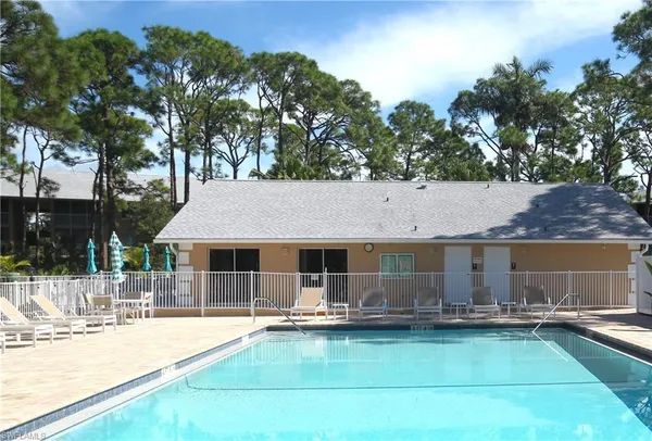a swimming pool with outdoor seating and yard