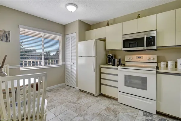 a kitchen with stainless steel appliances a stove microwave and refrigerator