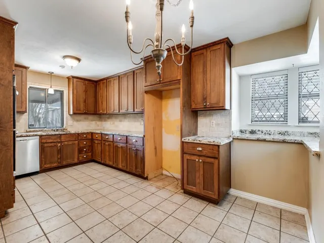 a kitchen with stainless steel appliances granite countertop a stove a sink dishwasher and a refrigerator