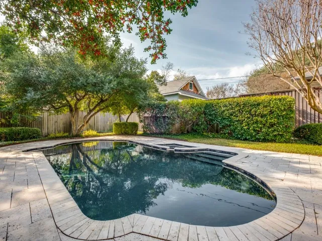 a view of a swimming pool with a patio