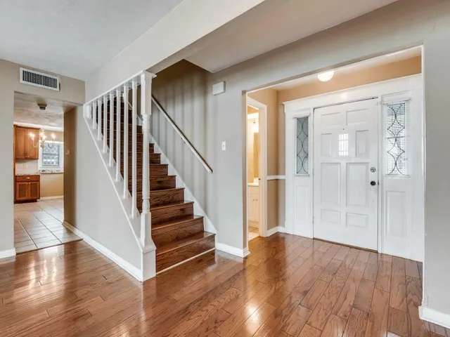 a view of entryway with wooden floor and stairs