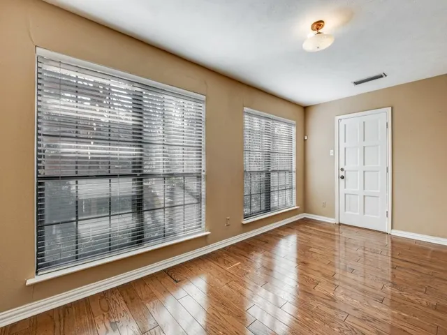 a view of wooden floor and windows in a room