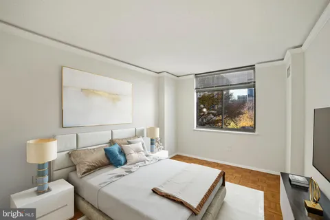 a bedroom with a bed and a lamp on table