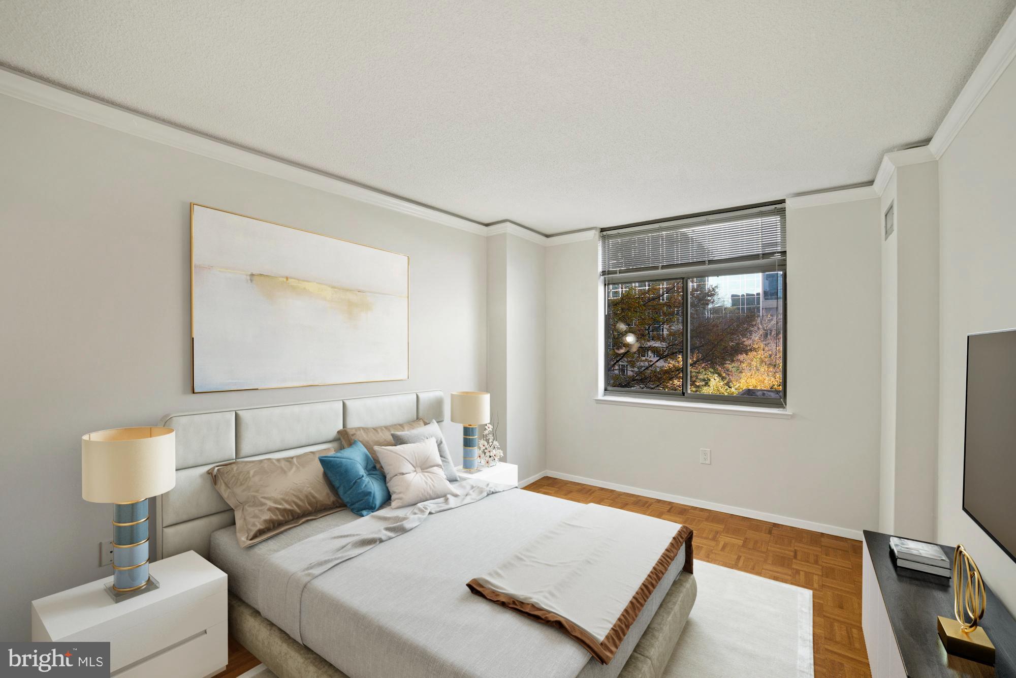 7111 Woodmont Avenue, Unit 514 Chevy Chase, MD 20815 - Photo 26 of 38 a bedroom with a bed and a lamp on table