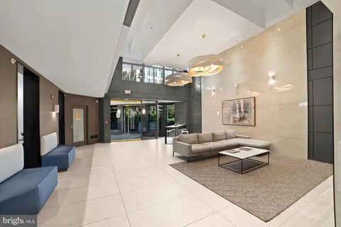 a living room with furniture and large windows