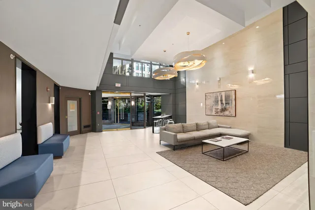 a living room with furniture and large windows