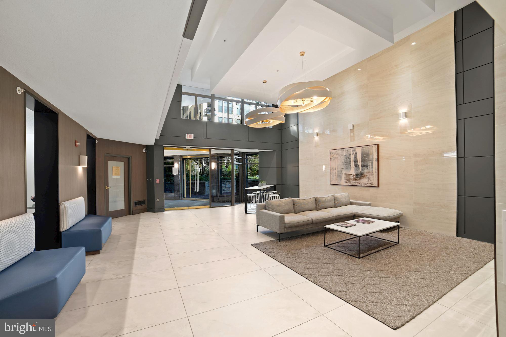 7111 Woodmont Avenue, Unit 514 Chevy Chase, MD 20815 - Photo 5 of 38 a living room with furniture and large windows