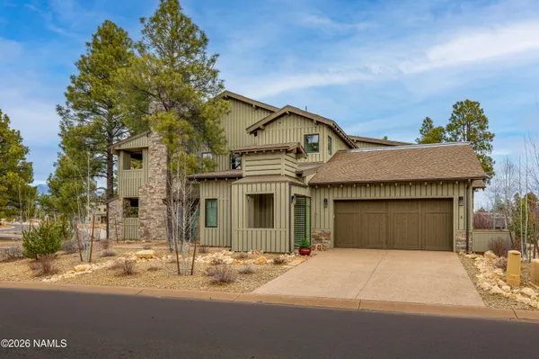 a view of a lake with a big yard and a large mountain view