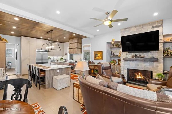 a living room with furniture a flat screen tv and a fireplace
