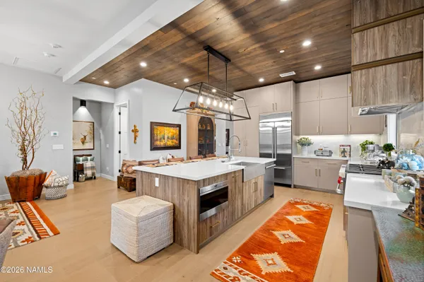a kitchen with a sink appliances and cabinets