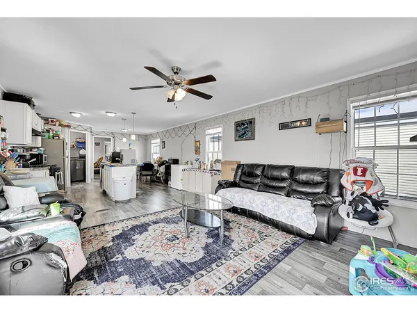 a living room with furniture and kitchen view