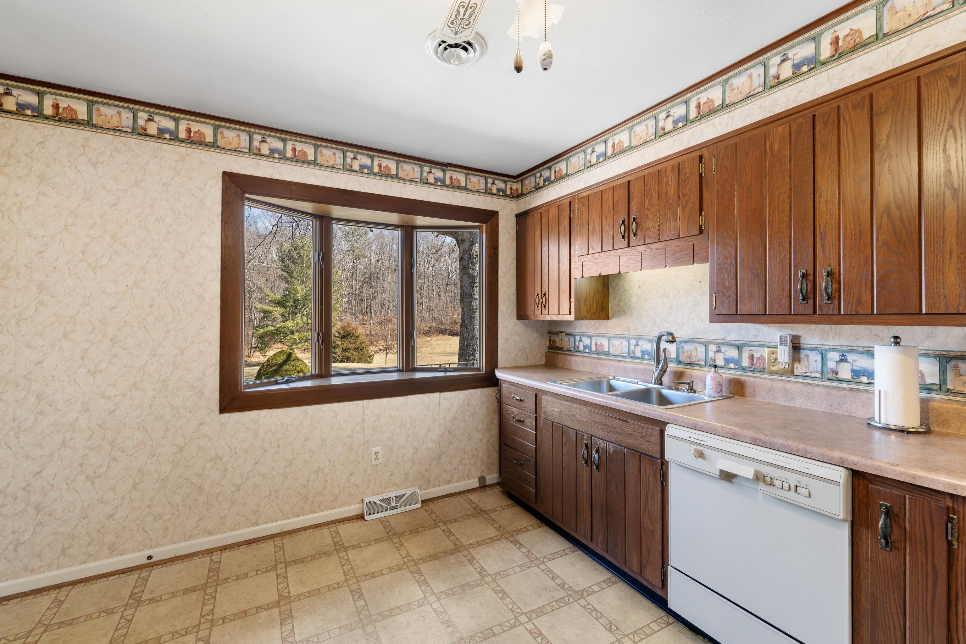 431 Mt Pisgah Road Mount Sidney, VA 24467 - Photo 23 of 72 a kitchen with a sink window and cabinets