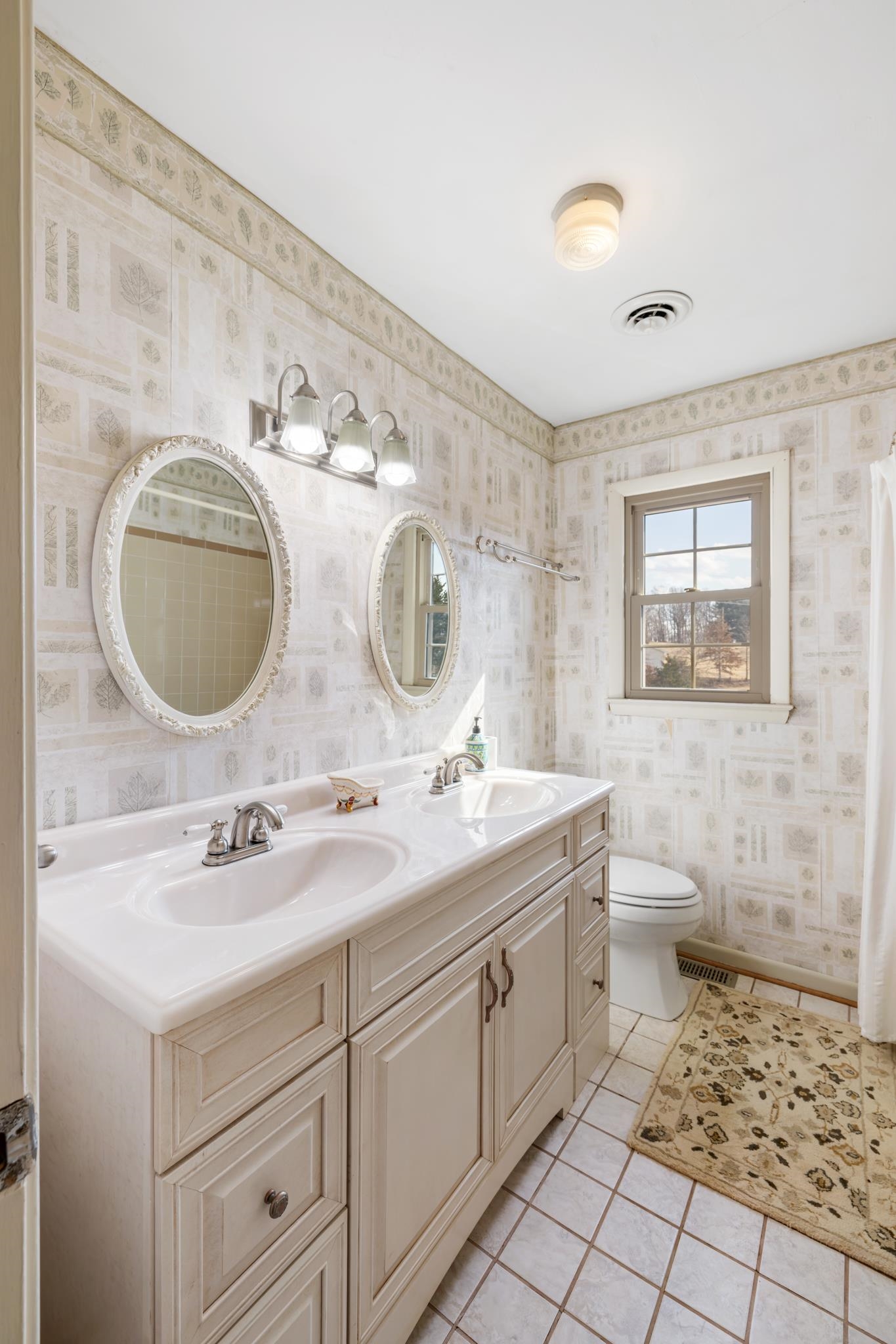 431 Mt Pisgah Road Mount Sidney, VA 24467 - Photo 52 of 72 a bathroom with a toilet sink double vanity and mirror