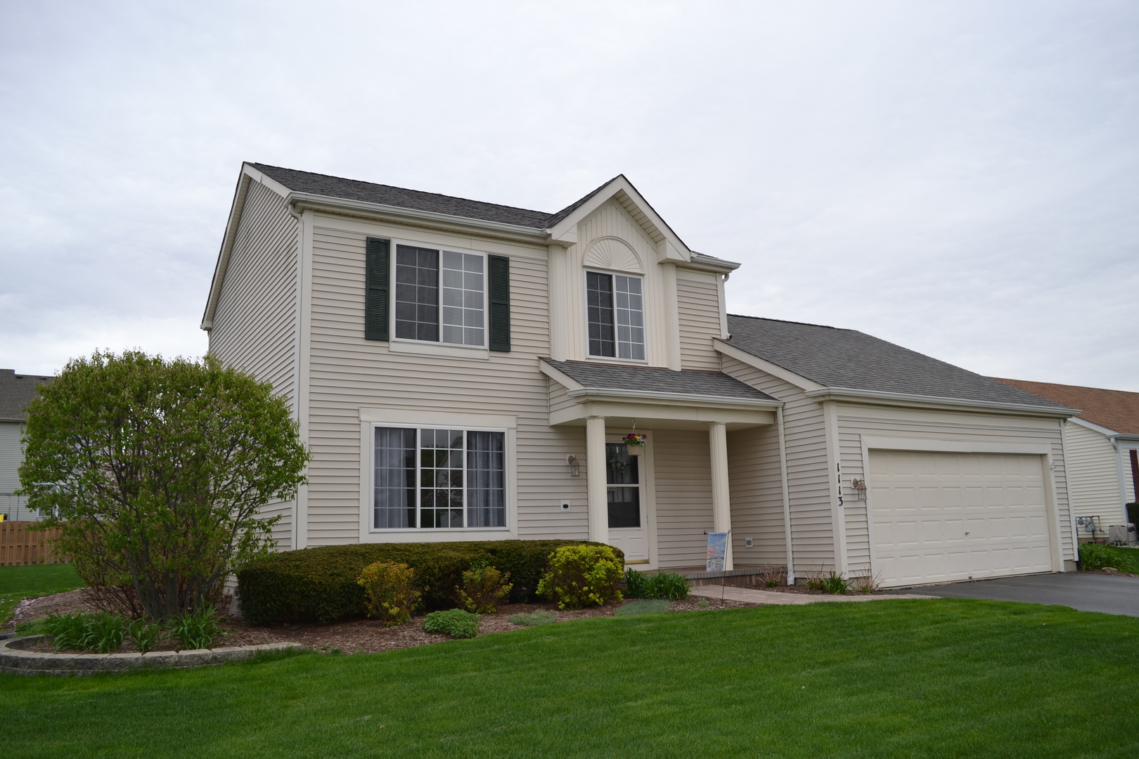 1113 Sawmill Lane Algonquin, IL 60102 - Photo 1 of 33 a front view of a house with a yard and garage