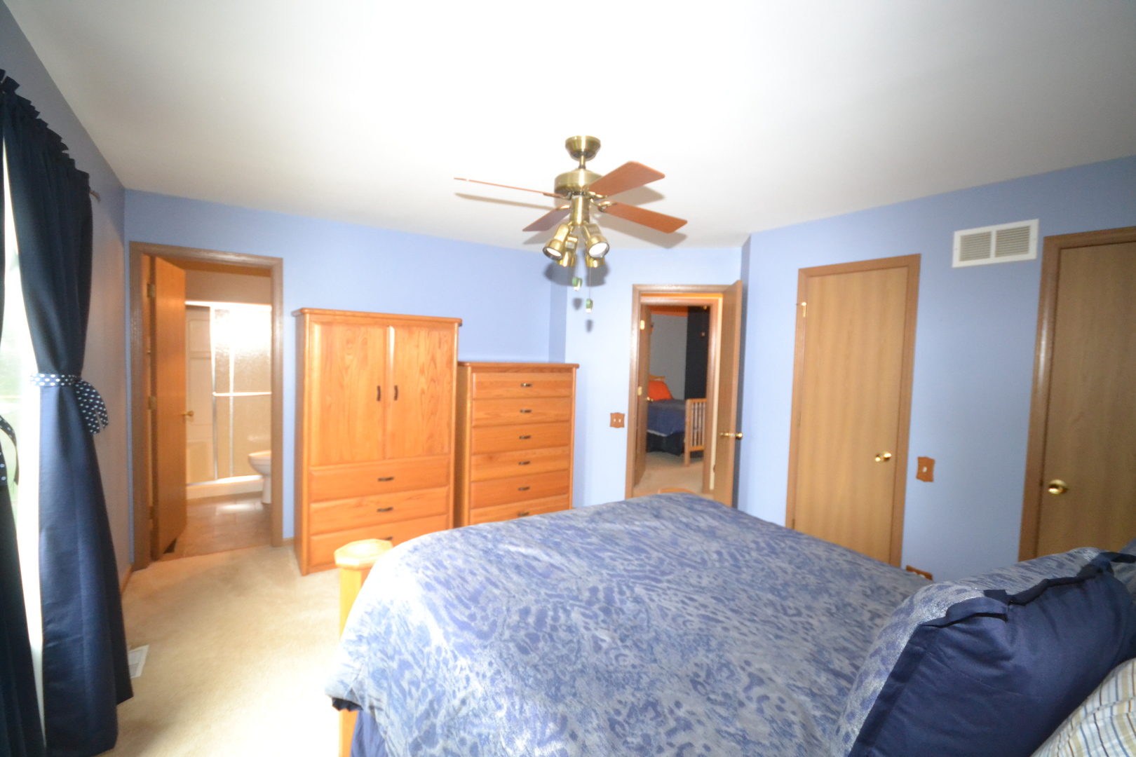 1113 Sawmill Lane Algonquin, IL 60102 - Photo 24 of 33 a bedroom with a bed dresser and a chandelier