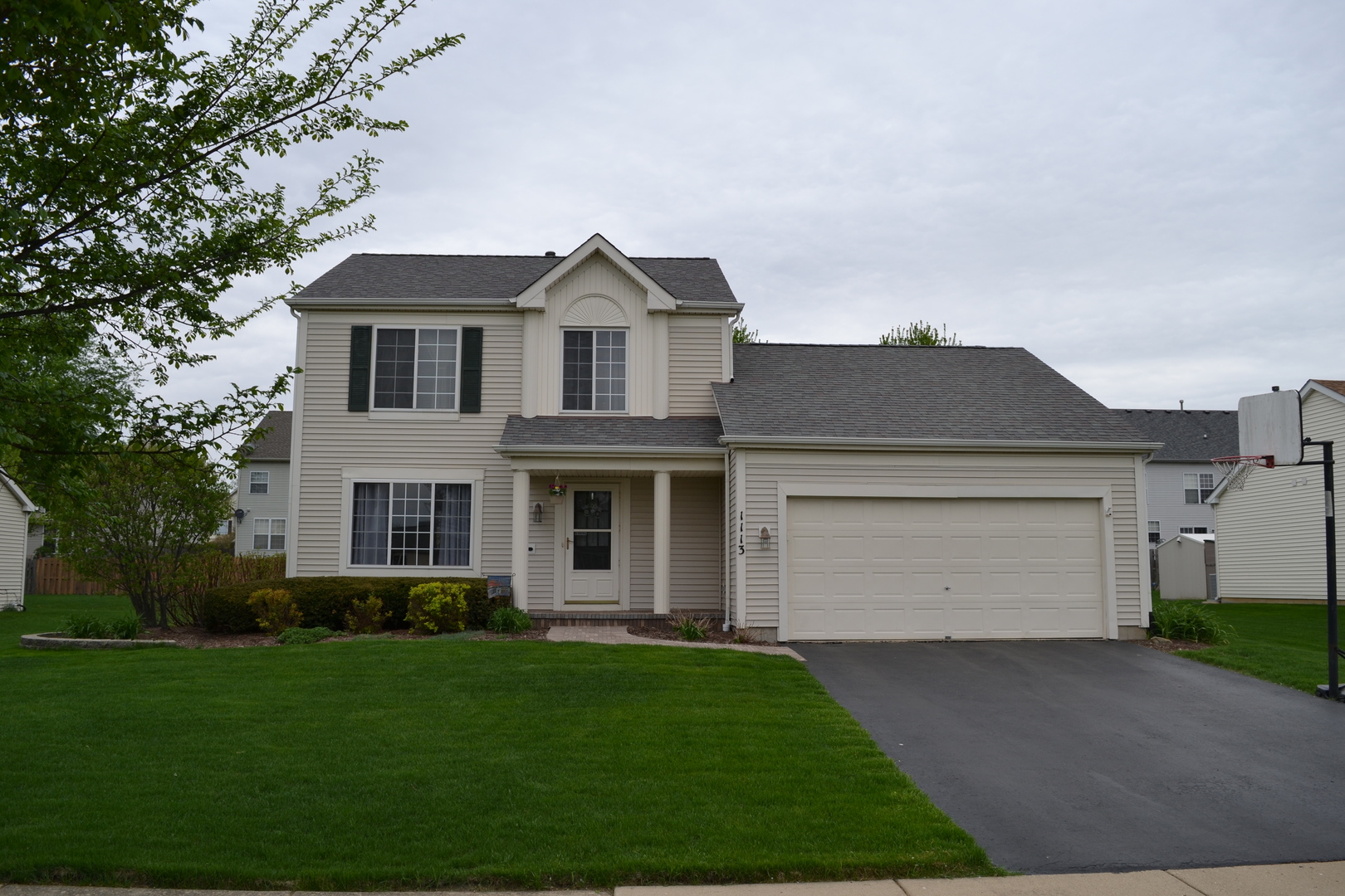 1113 Sawmill Lane Algonquin, IL 60102 - Photo 31 of 33 a front view of a house with a yard and garage