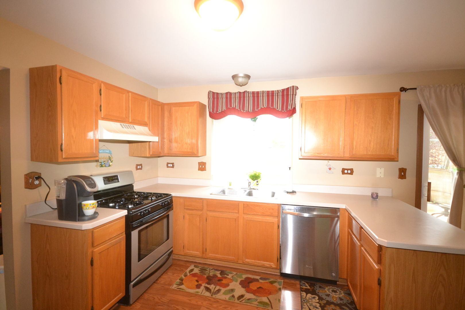 1113 Sawmill Lane Algonquin, IL 60102 - Photo 7 of 33 a kitchen with stainless steel appliances a sink a stove and a refrigerator