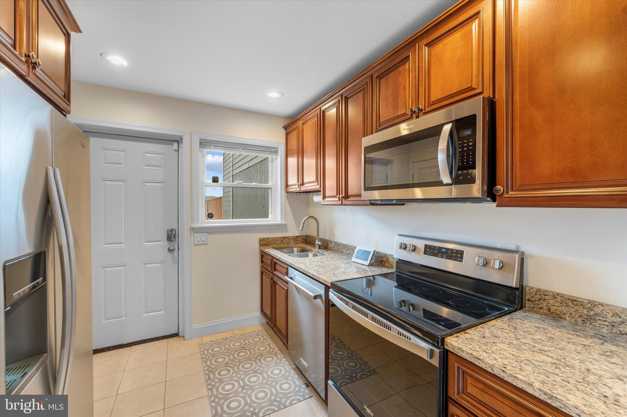 1527 K Street Southeast Washington, DC 20003 - Photo 11 of 27 a kitchen with stainless steel appliances granite countertop a stove microwave and refrigerator
