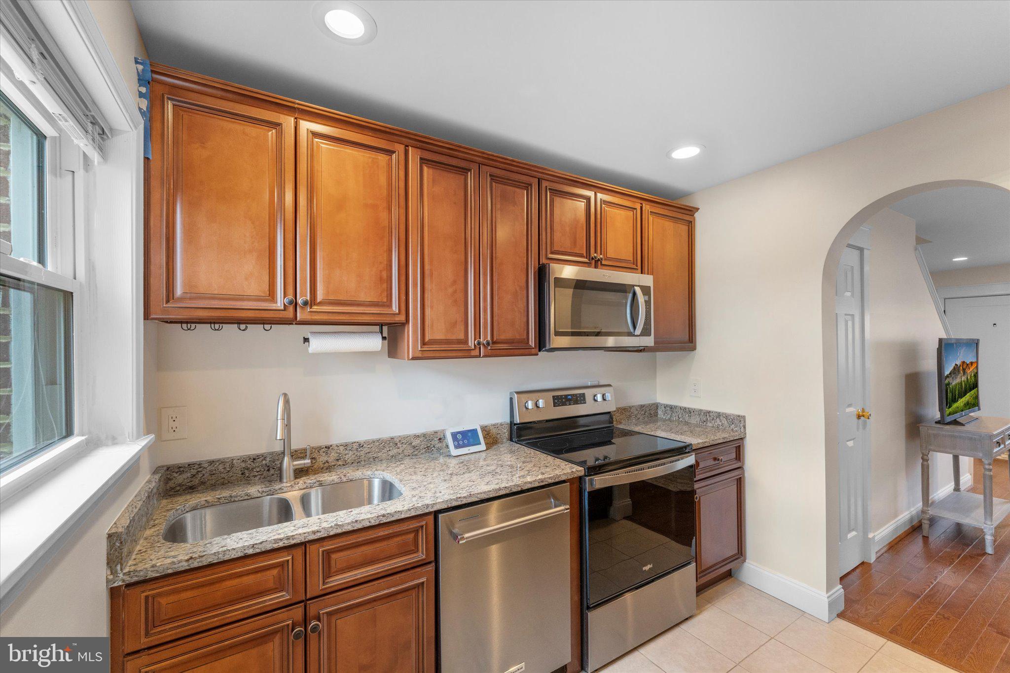 1527 K Street Southeast Washington, DC 20003 - Photo 13 of 27 a kitchen with granite countertop stainless steel appliances a sink stove and microwave