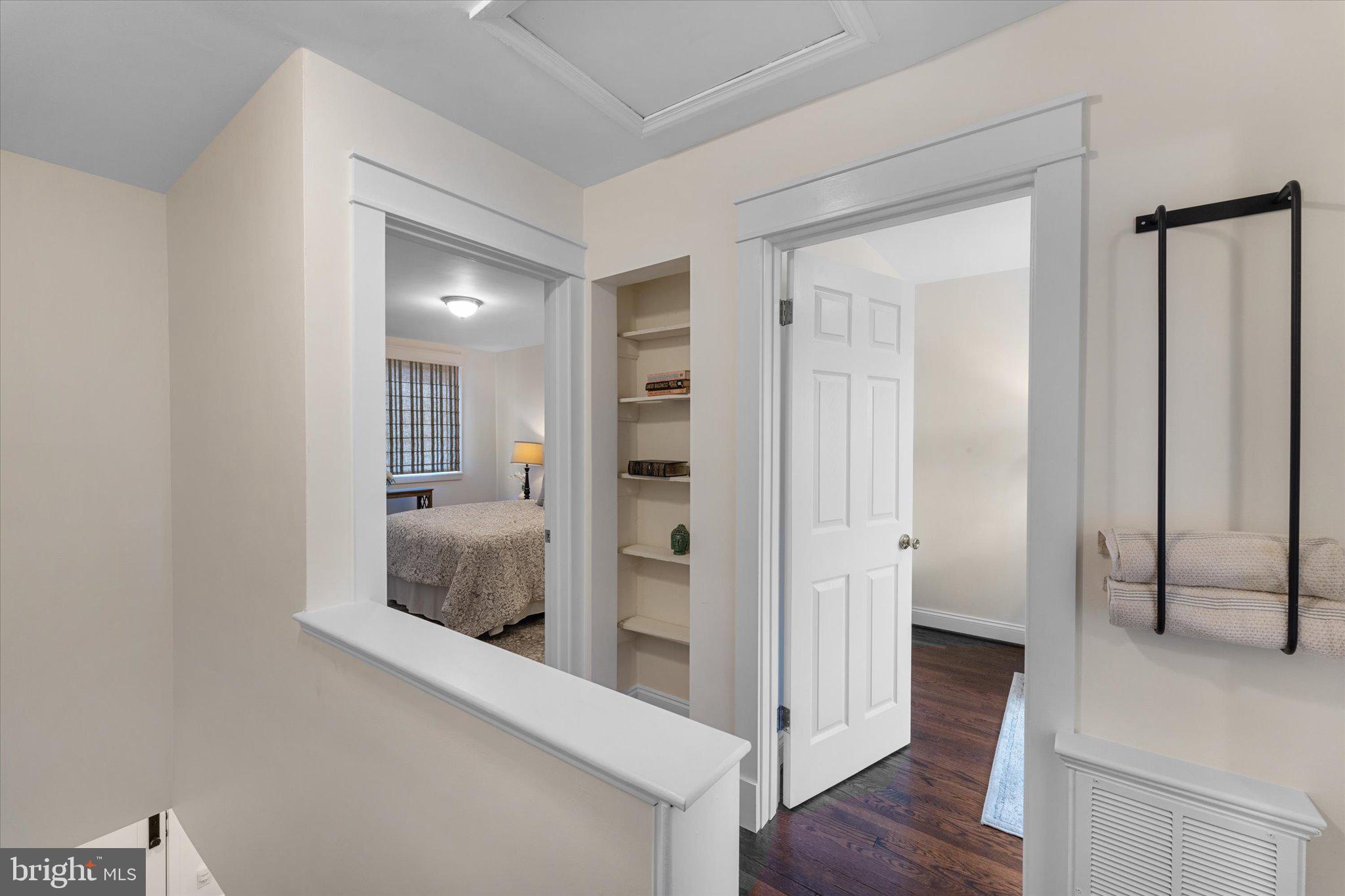 1527 K Street Southeast Washington, DC 20003 - Photo 15 of 27 a view of a hallway with wooden floor and bathroom