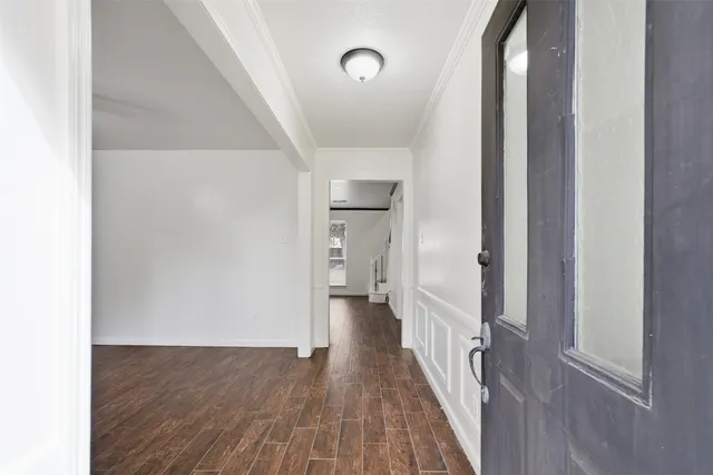 a kitchen with stainless steel appliances granite countertop a sink and cabinets with wooden floors