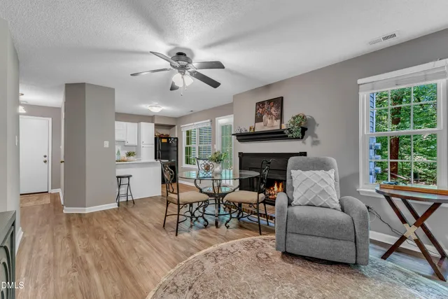 a living room with furniture a fireplace and a window