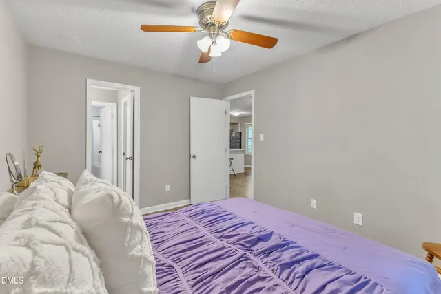 a bedroom with a bed and a chandelier