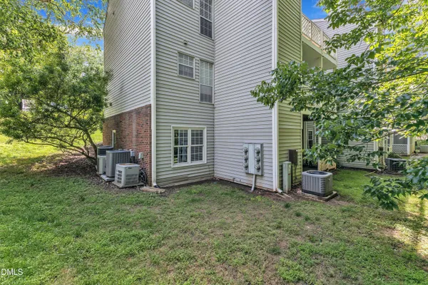 a view of a house with backyard and a tree