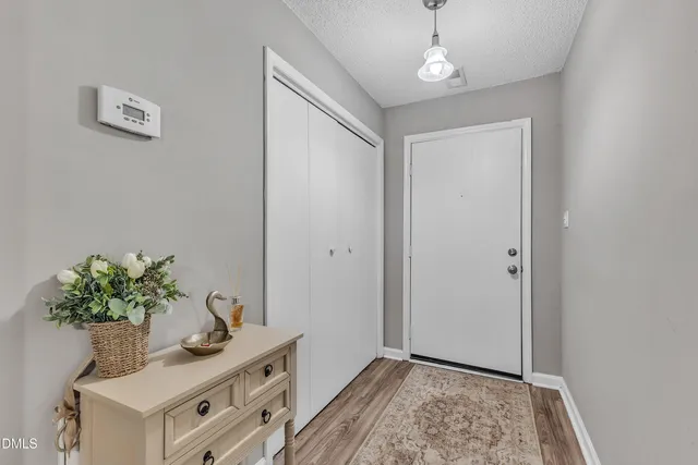 a view of an entryway with wooden floor