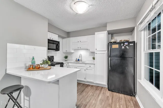 a kitchen with stainless steel appliances a refrigerator sink and cabinets
