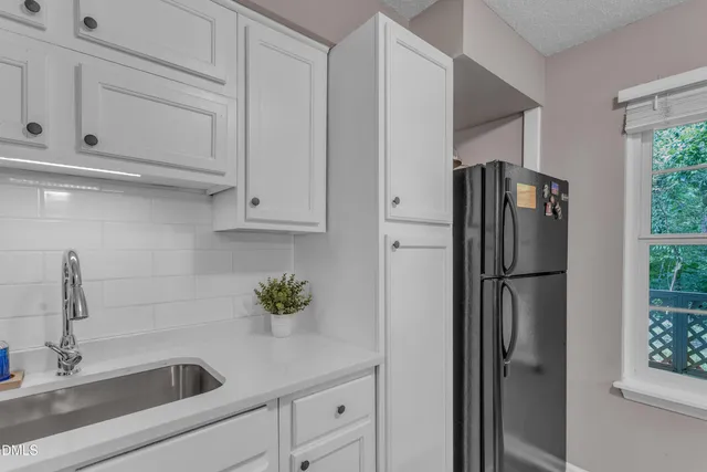 a kitchen with appliances and cabinets